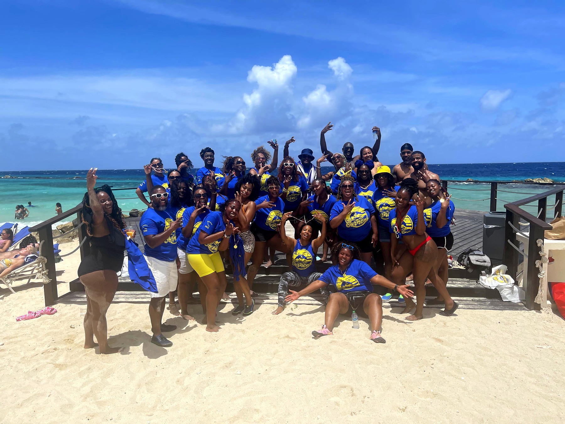 AFI travelers in coordinated blue and yellow by the coast